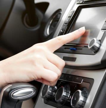 finger on dashboard with gps panel