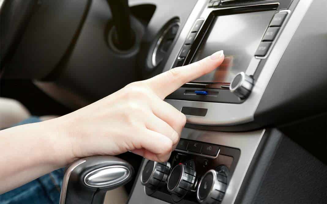 finger on dashboard with gps panel